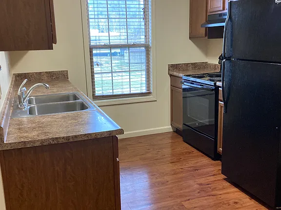 Kitchen with range, refrigerator, and window over the sink